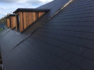 Slate roof with Sarnafil single membrane flat roofs on the dormers